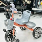Kids-Tricycle-with-Robot-Headlight-&-Basket-–-Stylish,-Sturdy-&-Fun-Ride.-Orange-strip
